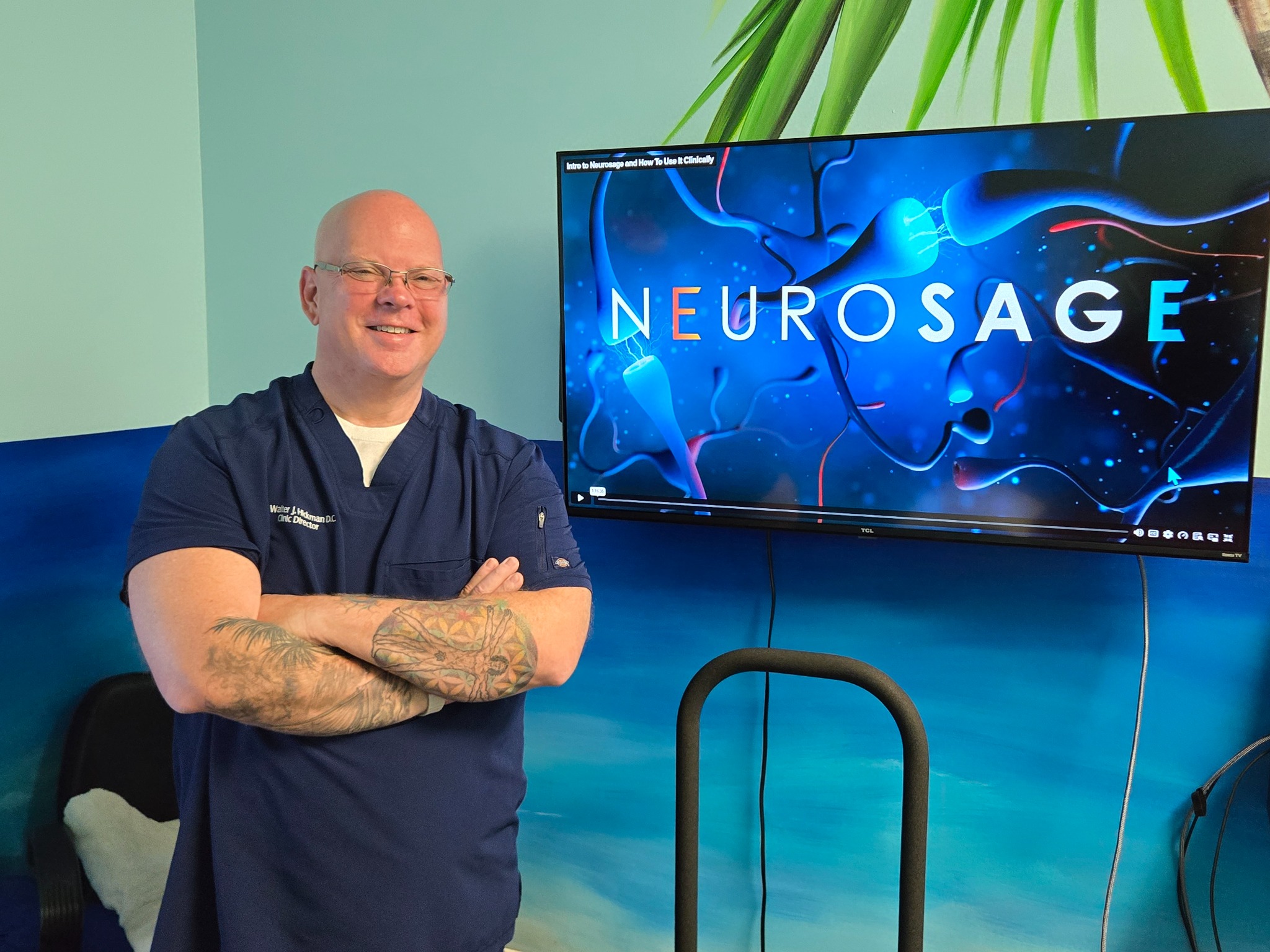 Dr. Hickman beside an interactive activity system in the practice
